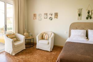 a bedroom with a bed and a chair at Aethria home,Nea artaki in Nea Artaki