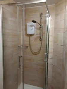 a shower in a bathroom with a glass door at Lovely flat in Gorgie, Edinburgh in Edinburgh +11 photos