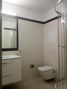 a bathroom with a toilet and a sink and a shower at Sun Akademie in Las Palmas de Gran Canaria