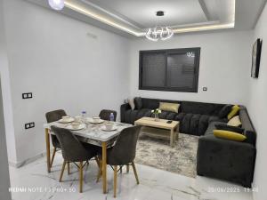 a living room with a table and a couch at modern apartment in Tangier