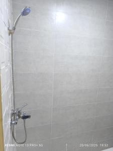 a shower with a shower head in a bathroom at modern apartment in Tangier +24 photos