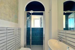 a bathroom with a shower and a tub and a sink at Borgo dei Saraceni - Domus Indomita in Agropoli +66 photos