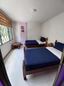 a bedroom with two beds and a window at centro bogota in Bogotá