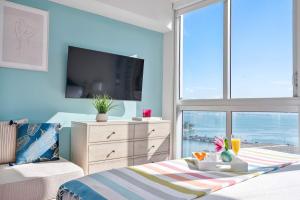 a bedroom with a bed with a tv and a window at MVR - Direct Bay View - Corner Smart TV in Miami