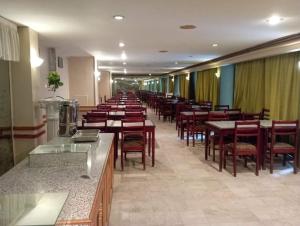 a long row of tables and chairs in a restaurant at Windsor Hotel Luxor 您在盧克索的第二個家 in Luxor