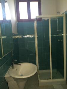 a bathroom with a shower and a toilet and a sink at Villa DonnAnna in Cariati