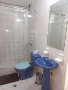 a bathroom with a blue toilet and a sink at centro bogota in Bogotá +40 photos