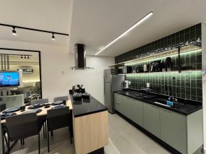 a large kitchen with a counter and a sink at Studio b2b in Florianópolis