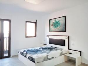 a bedroom with a bed in a white room at Sun Akademie in Las Palmas de Gran Canaria
