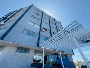 a man standing in front of a building at Barrudada Residence in Fortaleza