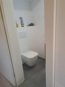 a bathroom with a toilet in a white room at Mini Loft 30 - Apartment 3 