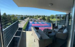 a balcony with a view of a swimming pool at Greenbay Golf Apartments in Trenčín