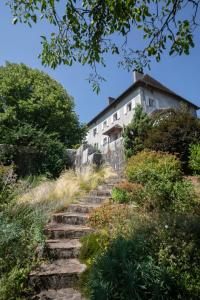 a house on top of a hill with stairs at Havre de paix au coeur du Bugey in Magnieu