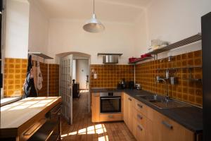 a kitchen with a sink and a stove top oven at Havre de paix au coeur du Bugey in Magnieu