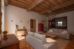 a living room with a couch and a table at Havre de paix au coeur du Bugey in Magnieu +33 photos