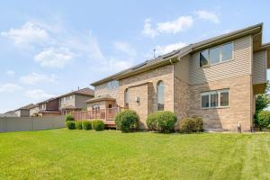 a large house with a lawn in front of it at Game Room and Deck Family Home in Chicago Area! in Matteson