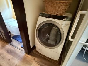a washing machine with a basket on top of it at 天空のお宿 雅館 in Ichinoseki