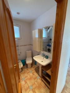 a bathroom with a sink and a toilet and a mirror at Villa El Faro in Peñíscola +22 photos