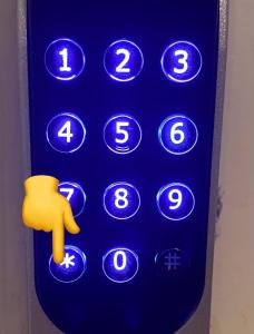 a remote control with a finger pointing to the number keys at Kopsamonlinna in Juupajoki