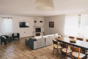 a living room with a couch and a table at Wildwood Villa in Apriltsi