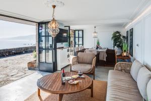 a living room with a table and a view of the ocean at VILLA EMBIL GETARIA in Getaria