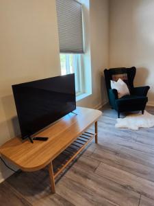 een woonkamer met een flatscreen-tv op een salontafel bij Modern apartment overlooking a Historic Downtown in Elloree