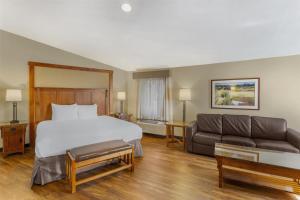 a hotel room with a bed and a couch at Best Western Plus High Country Inn in Ogden +41 photos