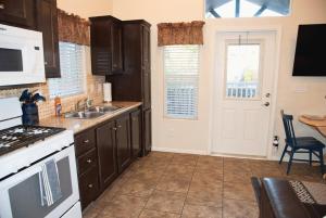 a kitchen with a sink and a stove top oven at Portal Overlook Cabin #14 in Moab