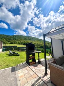 a grill on a patio with a view of a mountain at Melissa luxury Apartment in Bijelo Brdo