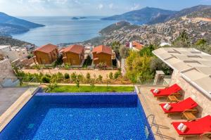 a villa with a swimming pool and a view of the ocean at Eco Villa BEGONVİL in Kalkan