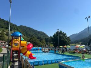 ein Wasserpark mit Wasserrutsche und Spielplatz in der Unterkunft Casa Willigio in Roncone