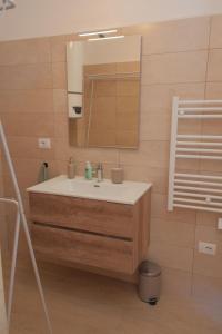 a bathroom with a sink and a mirror at NELIS HOUSE - Casa in montagna - Ateleta in Ateleta +5 photos