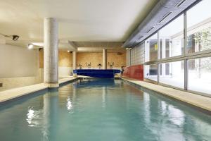 a swimming pool with blue water in a building at El Patio de la Catedral in Salamanca