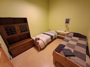 a bedroom with two beds and a small table at Atpūtas komplekss Cerības 