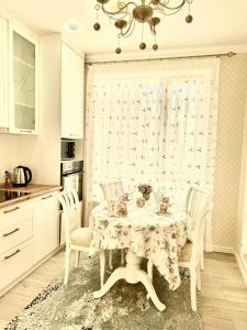 a dining room with a table and chairs at Уютные Апартаменты в ЖК Life Park in Astana