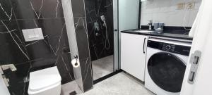 a small bathroom with a washing machine in it at Yasmine Suit in Trabzon +29 photos