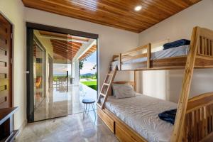 a bedroom with bunk beds in a house at Hacienda Jaguar - by Pura Villas in Ojochal