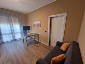 a living room with a couch and a table and a door at Casa Gemma in Padova
