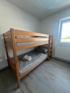 a wooden bunk bed in a room with a window at Melissa luxury Apartment in Bijelo Brdo +29 photos