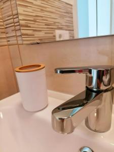 a roll of toilet paper sitting on top of a sink at Mar Airport-Park by Babiniliving in Costa de Antigua
