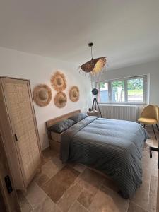 a bedroom with a bed and baskets on the wall at Le Cocon de Vlinette in Brienne-le-Château