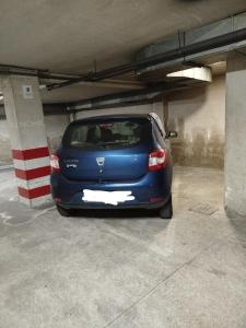 a blue car parked in a parking garage at Ático Milladoiro in Milladoiro +8 photos