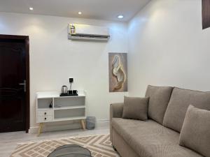 a living room with a couch and a air conditioner at شقة غرفه وصاله راقيه 2 العريض in Al Madinah
