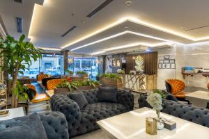 a large living room with couches and tables at Gacine Hotel Tahlia فندق غسن التحلية in Al Madinah +38 photos
