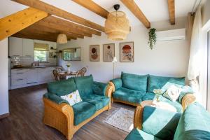 a living room with blue couches and a kitchen at Symbioza Grabnik in Stare Juchy