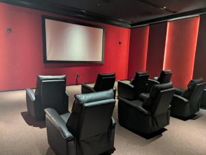 a waiting room with black chairs and a screen at Ocean View Apartment in Manama +10 photos