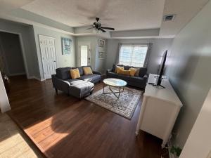 a living room with a couch and a table at Spacious 3BR Home Sleeps 12 Near Valdosta in Hahira
