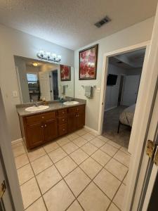 a bathroom with two sinks and a large mirror at Spacious 3BR Home Sleeps 12 Near Valdosta in Hahira