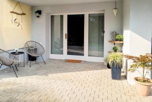 a patio with chairs and a sliding glass door at Ferienwohnung Landruhe in Katharinenberg