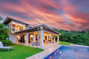 a house with a pool in front of it at Hacienda Jaguar - by Pura Villas in Ojochal +37 photos